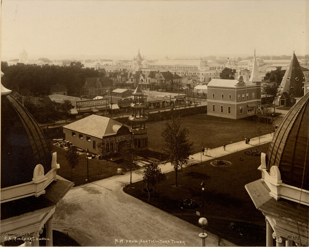 Looking northwest from Horticulture Towers. Chinese Exhibit, Montana State Building, Pottawattamie County Wigwam to the northwest. In the distance are the International Dining Hall, Columbia Restaurant, Elite Dining Hall, and Spearman Brothers Lunch Room, residential housing, and Grand Court.