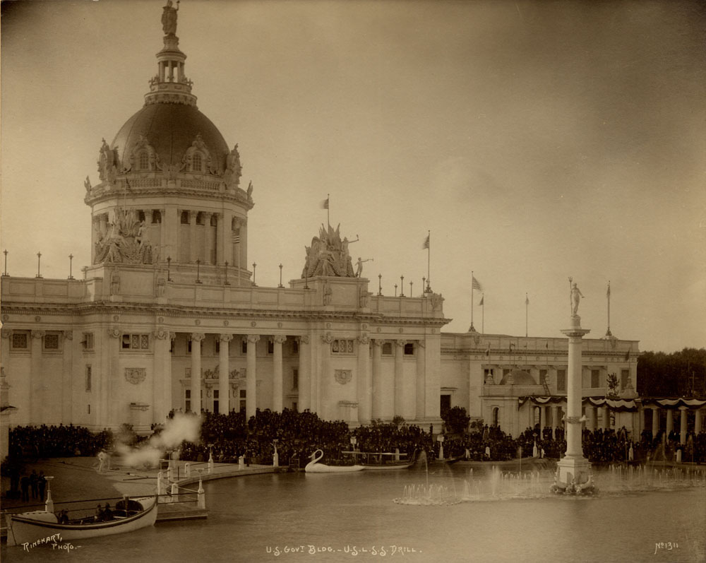 U.S. Government Building looking northwest. U.S. Life Saving Service Drill. Crowd gathered in front of building, smoke drifting from USLSS, swan boat, gondolas, and USLSS boats in lagoon. Fountain of Neptune turned on with waters at low level.