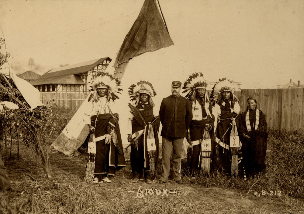 Group Portrait of Indian Congress Participants. Sioux Delegates. Unidentified Man, Turning Eagle, Captain W. A. Mercer, Afraid of Eagle, Unidentified Man, and Unidentified Woman
