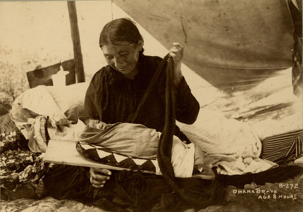 Mother swaddling newborn son, born at the Indian Congress eight hours prior. Mother is an Omaha delegate--possibly Mrs. Spotted Back.