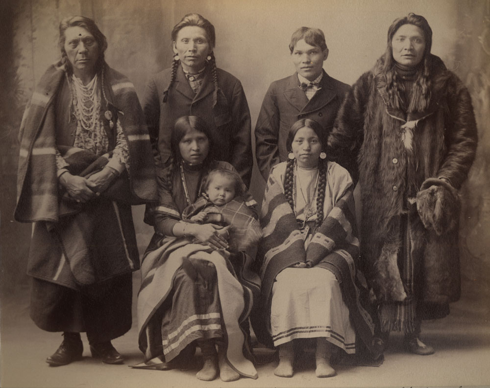 Group Portrait of Indian Congress Participants. Salish (Flathead) Delegates. Back Row: Chief Antoine Moise, Paul Antoine, Moses Delaware, Kicking Horse; Front Row: Katherine Antoine (holding infant), Adelaide Kicking Horse