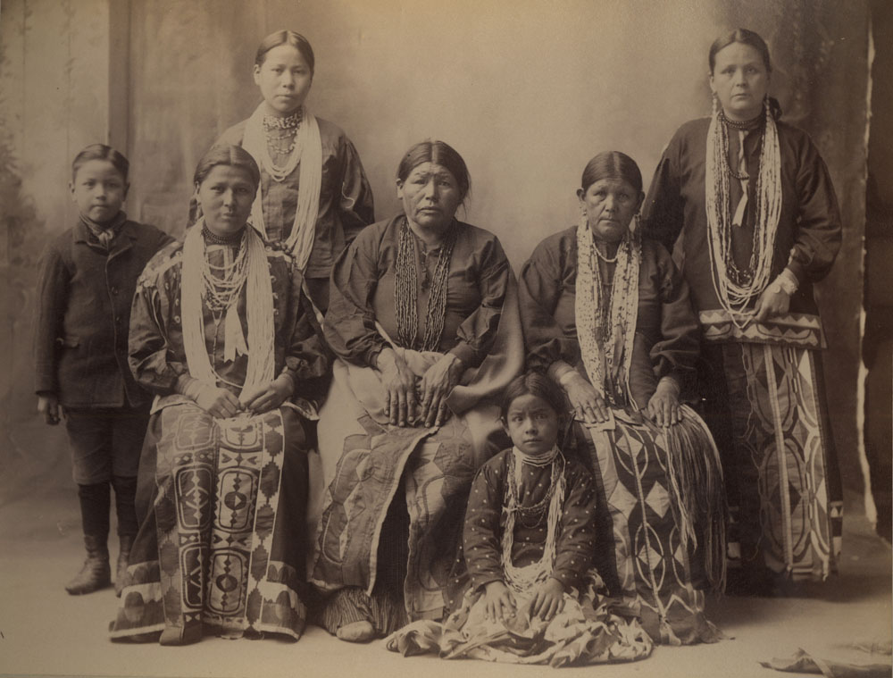 Group Portrait of Indian Congress Participants. Winnebago Delegates. Mrs. Black Hawk and six others. Louisa Johnson (seated, far left)