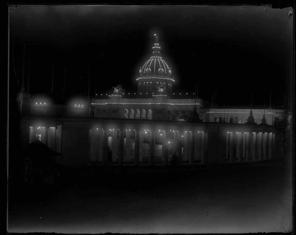 U.S. Government Building at night from behind west colonnade, looking southwest.