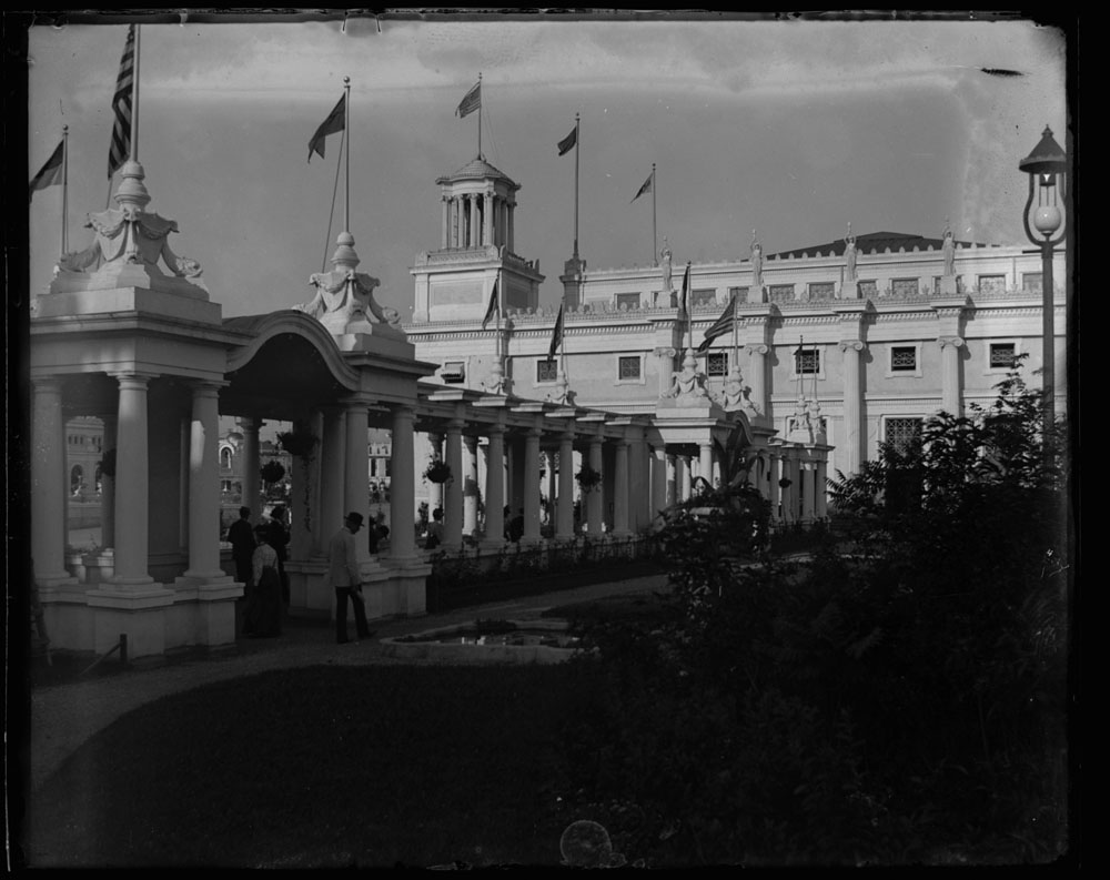 Mines and Mining Building and colonnade looking northeast. People standing within and next to Colonnade.