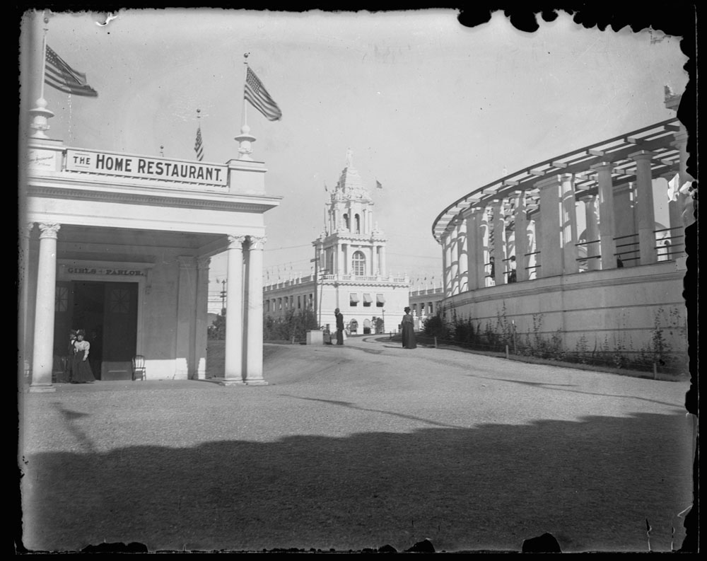 Girls' and Boy's Building, Twin Tower Restaurant, and Grand Colonnade. A few people walking.
