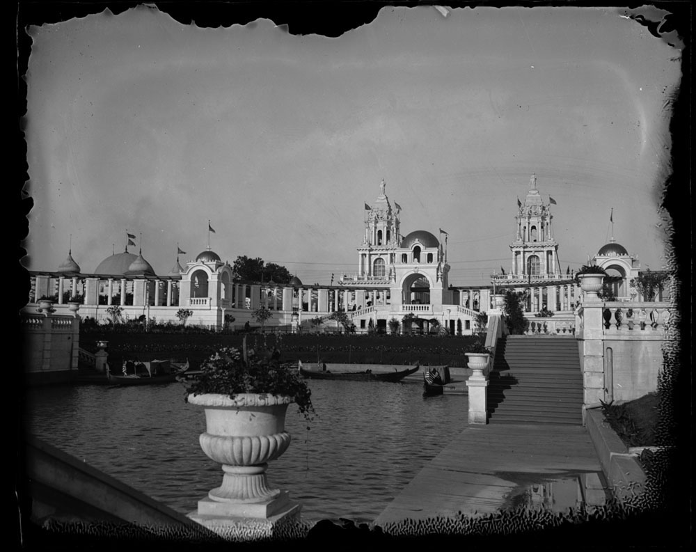 East end of lagoon, looking toward Grand Colonnade from stairway to lagoon. Gondolas in lagoon. Moorish Palace and Twin Towers Restaurant visible beyind Grand Colonnade.