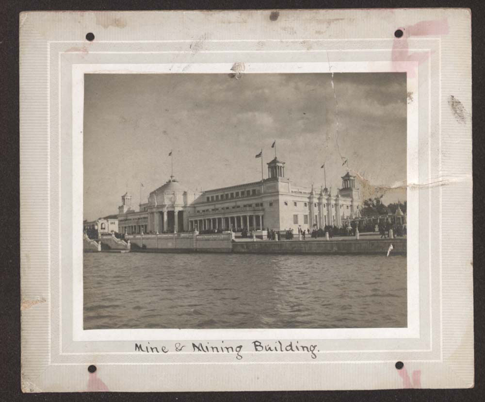 View of Mines and Mining Building looking southeast across lagoon. Light crowd walking.