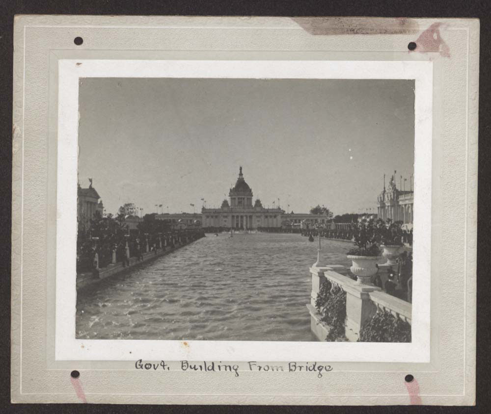 View of U.S. Government Building from across lagoon, looking west. Fine Arts Building to the south, and Agriculture Building to the north. Balustraded Island in foreground.
