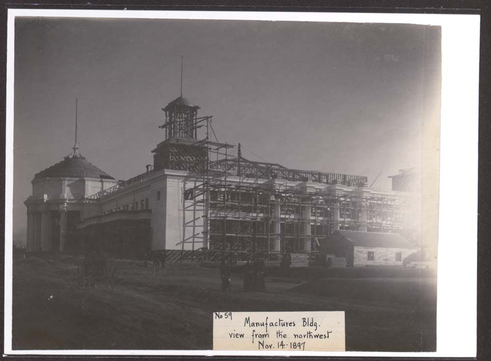Construction of Mines and Mining Building. Horse drawn carriage and several groups of people near structure.