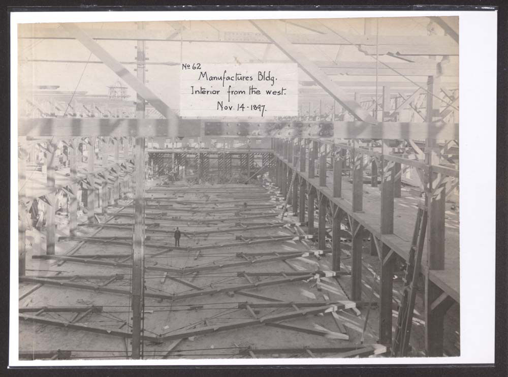 Interior view of Mines and Mining Building Construction. Man poses.