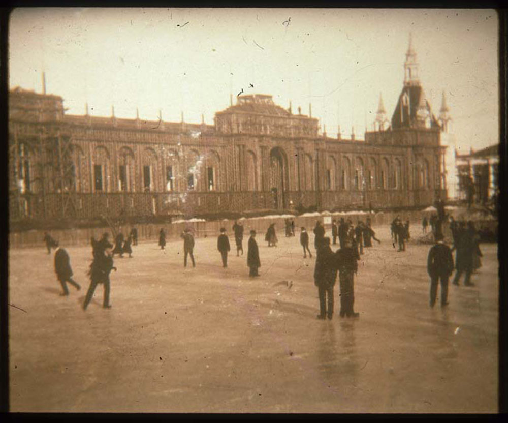 Ice skaters on lagoon. Agriculture Building and Administration Arch in background.