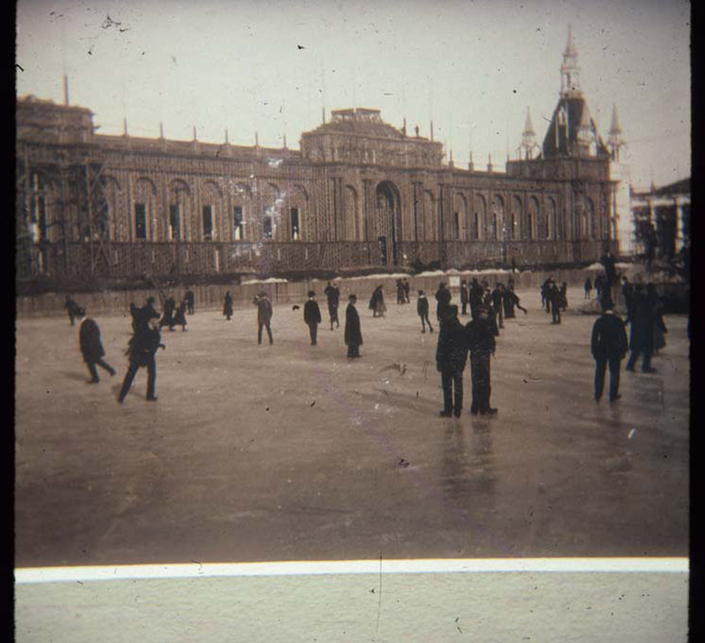 Ice skaters on lagoon. Agriculture Building and Administration Arch in background.